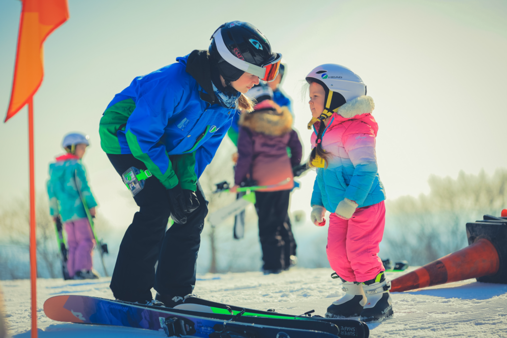 Two kids looking at each other ready to ski